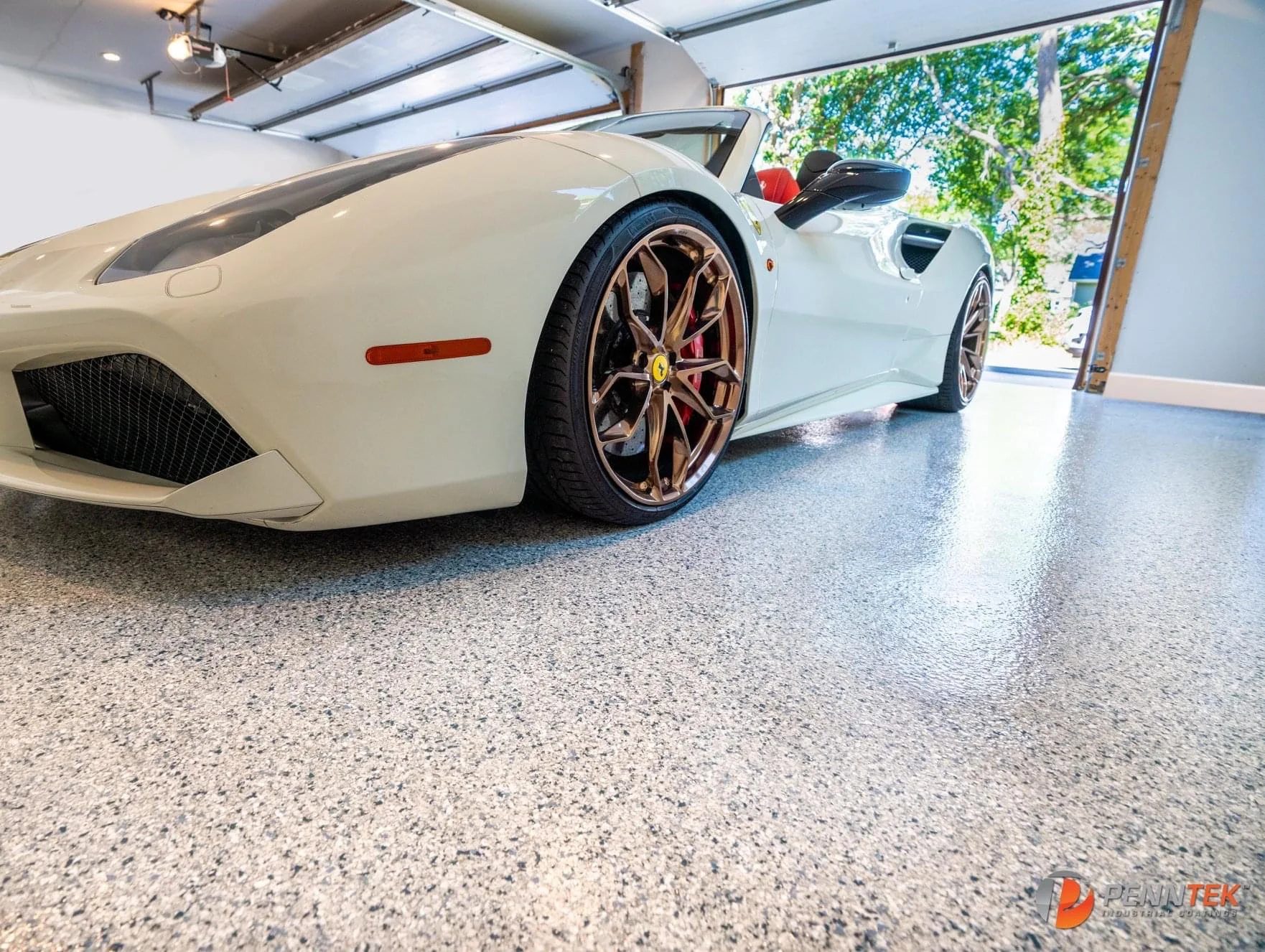 White Ferrari parked on a finished residential garage floor coating.