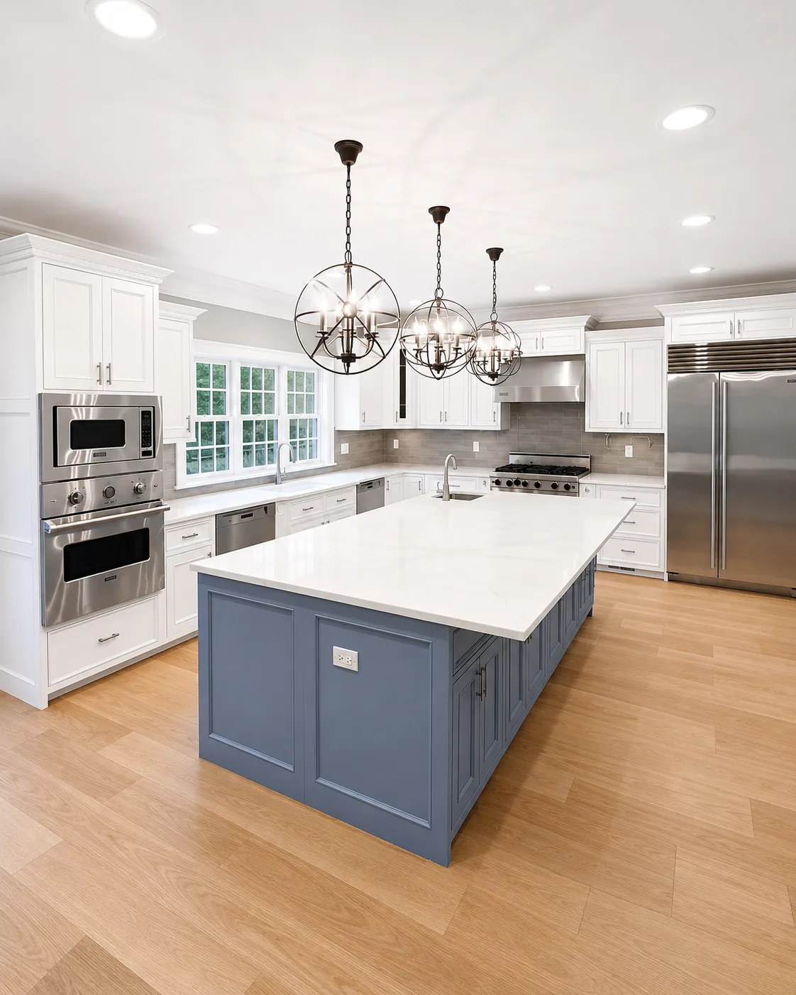 Finished Bedford Hills kitchen with a blue painted island, white cabinetry, and detailed interior trim.