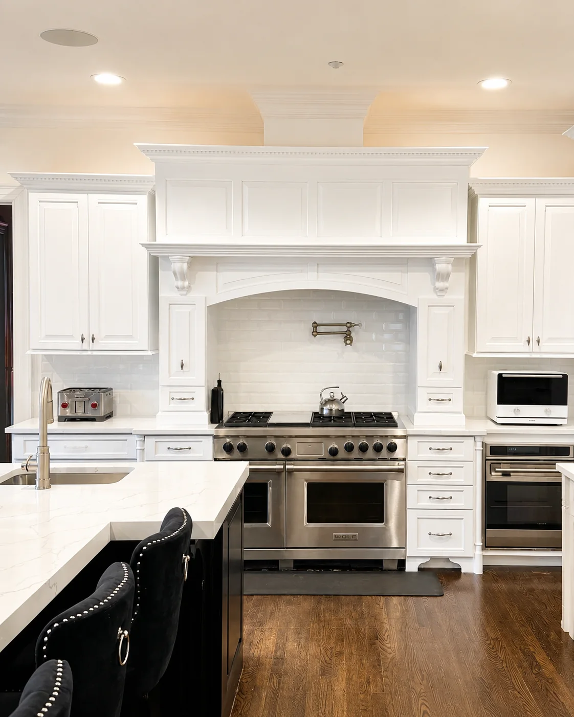 Kitchen with white painted cabinetry after interior painting.