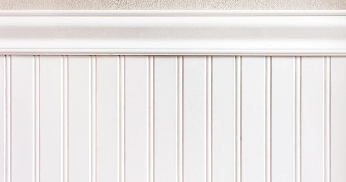 Close view of finished white beadboard, chair rail, and wall molding.