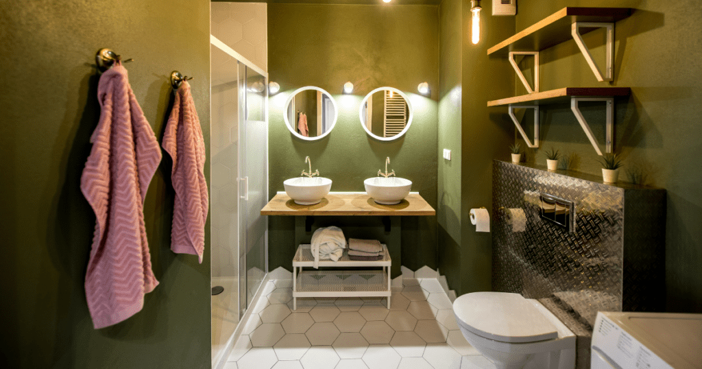 Luxurious bathroom featuring deep green walls, white hexagonal tiles, and wooden accents.