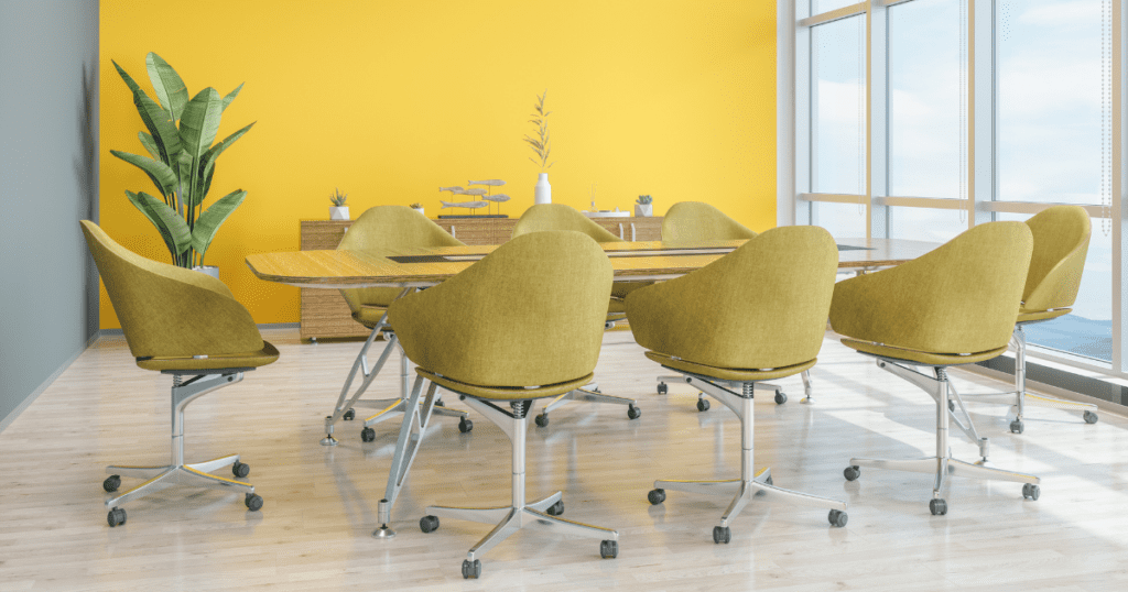 Vibrant office space with yellow walls, green chairs, and a panoramic view.