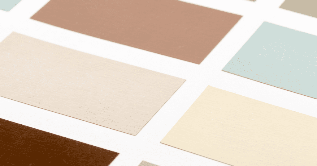 Close-up of neutral color paint swatches arranged in rows.