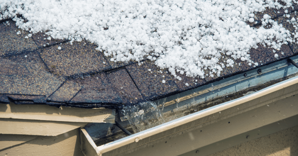 Snow and ice accumulation on a residential rooftop and gutters.