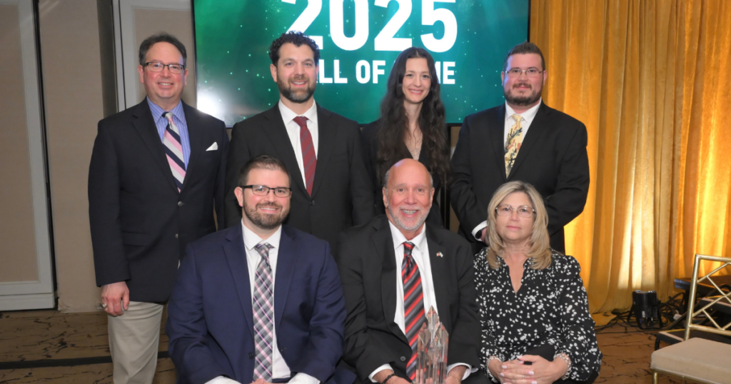Back row, left to right: Carey Hollander, Paul Viggiano, PJ Matys, and Nicholas Williams. Front row, left to right: George Williams Jr., George Williams Sr., and Theresa Williams. Seven proud members of the A.G. Williams Painting Company team gather at the 2025 Hall of Fame awards ceremony, standing in front of the event's official backdrop. The group reflects the company's multi-generational leadership, unified vision, and unwavering dedication to excellence in the painting industry. Photo courtesy of John Vecchiolla.
